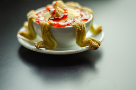 Cake baked in the shape of a monster in a ceramic bowl, sweet for Halloween, scary foodの写真素材