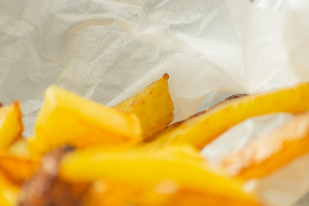 Closeup of golden fries prepared from fresh potatoes, greasy but delicious food, unhealthyの写真素材