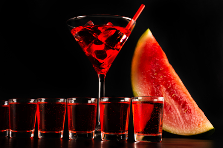 Red refreshing drink on the basis of watermelon on a black background, party nightの写真素材