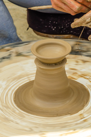 Closeup of the hands of the artist creating a clay pot, the traditional method of creating ceramic products, hobbiesの写真素材