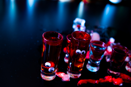 Creepy Halloween party cocktails with blood, spiders and ice cubes, drinks at partyの写真素材