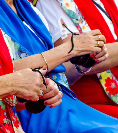 Close up hands with castanets of women during the presentation of a group cultivating the Spanish tradition, musical instrumentsの写真素材