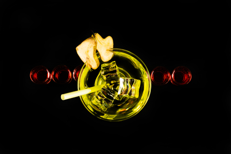 Green refreshing drink on the basis of pear on a black background, party nightの写真素材