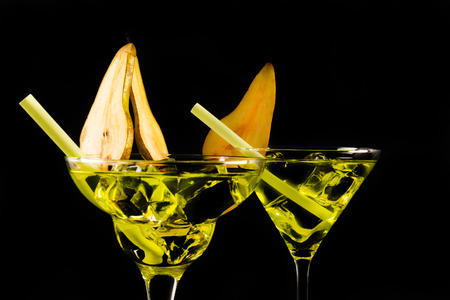 Green refreshing drink on the basis of pear on a black background, party nightの写真素材