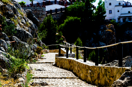 Tourist path in a mountainous Spanish town, a pedestrian trail secured with a rope, active restの写真素材