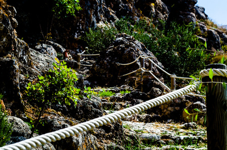 Tourist path in a mountainous Spanish town, a pedestrian trail secured with a rope, active restの写真素材