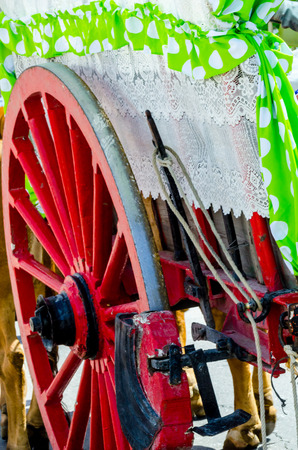 Old rusty circle wheel detail with a wagon, a traditional element of an old Spanish cart, vintageの写真素材
