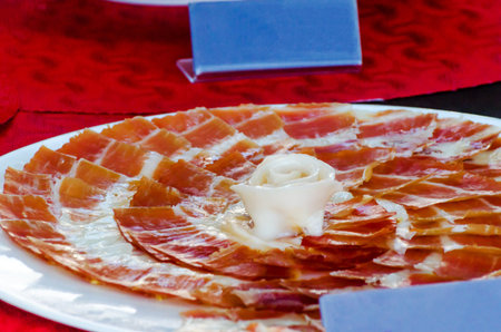 Plate with cut slices of jamon serrano, traditional Spanish ham, meat