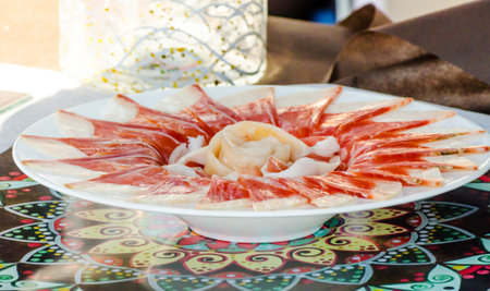 Plate with cut slices of jamon serrano, traditional Spanish ham, meat