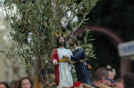 Procession of children starting the holy week.Children in the procession wear platforms with images...