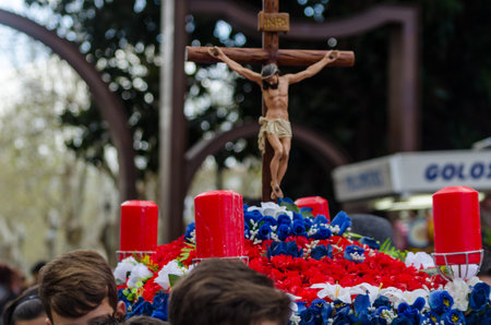 Procession of children starting the holy week.Children in the procession wear platforms with images...