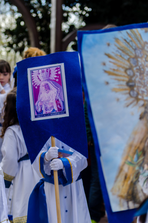 Procession of children starting the holy week.
Children in the procession wear platforms with images of saints. Traditional celebration of the Catholic holiday in Andalusia.のeditorial素材