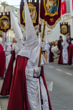 VELEZ-MALAGA, SPAIN - MARCH 25, 2018 People participating in the procession connected in a holy week...