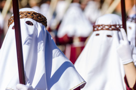 VELEZ-MALAGA, SPAIN - MARCH 27, 2018 People participating in the procession  in the Holy Week in a...