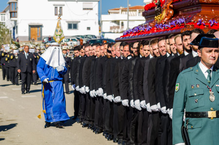 VELEZ-MALAGA, SPAIN - MARCH 27, 2018 People participating in the procession  in the Holy Week in a...