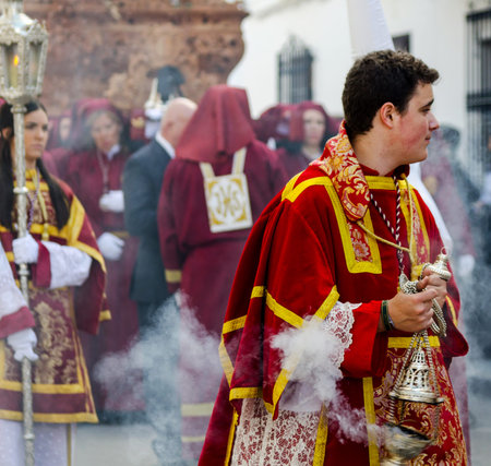 VELEZ-MALAGA, SPAIN - MARCH 25, 2018 People participating in the procession  in the Holy Week in a...