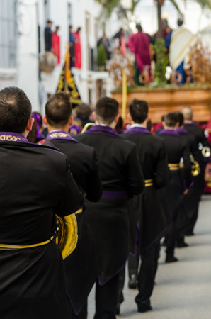 VELEZ-MALAGA, SPAIN - MARCH 25, 2018 People participating in the procession  in the Holy Week in a...