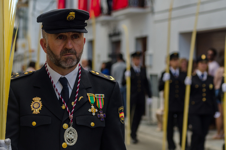 VELEZ-MALAGA, SPAIN - MARCH 25, 2018 People participating in the procession  in the Holy Week in a Spanish city, easterのeditorial素材