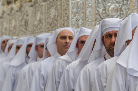 VELEZ-MALAGA, SPAIN - MARCH 25, 2018 People participating in the procession  in the Holy Week in a...