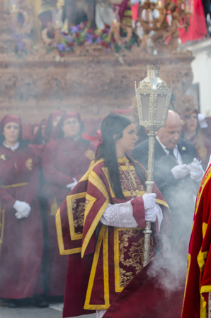 VELEZ-MALAGA, SPAIN - MARCH 25, 2018 People participating in the procession  in the Holy Week in a Spanish city, easterのeditorial素材