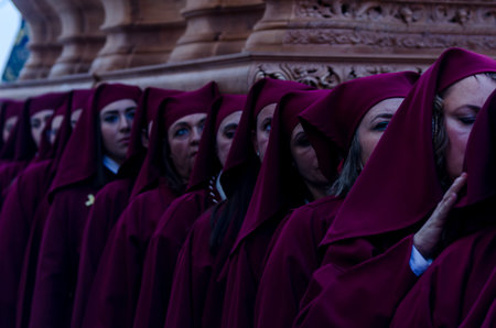 VELEZ-MALAGA, SPAIN - MARCH 25, 2018 People participating in the procession  in the Holy Week in a...