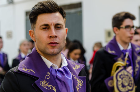 VELEZ-MALAGA, SPAIN - MARCH 25, 2018 People participating in the procession  in the Holy Week in a...