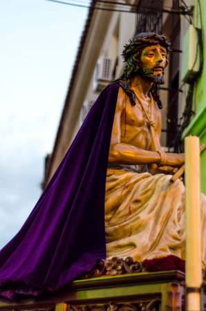 VELEZ-MALAGA, SPAIN - MARCH 24, 2018 People participating in the procession  in the Holy Week in a...