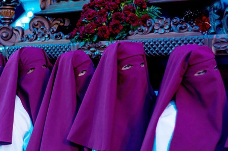 VELEZ-MALAGA, SPAIN - MARCH 24, 2018 People participating in the procession  in the Holy Week in a...