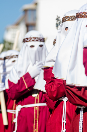 VELEZ-MALAGA, SPAIN - MARCH 27, 2018 People participating in the procession  in the Holy Week in a Spanish city, easterのeditorial素材
