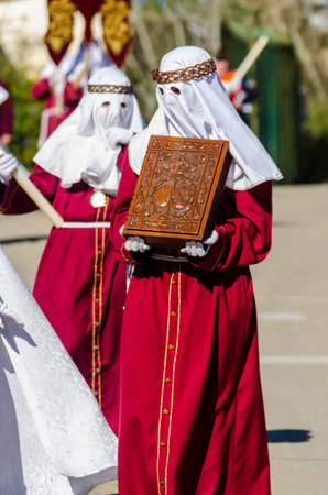 VELEZ-MALAGA, SPAIN - MARCH 27, 2018 People participating in the procession  in the Holy Week in a...