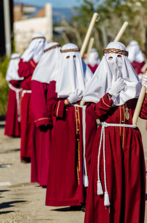 VELEZ-MALAGA, SPAIN - MARCH 27, 2018 People participating in the procession  in the Holy Week in a...