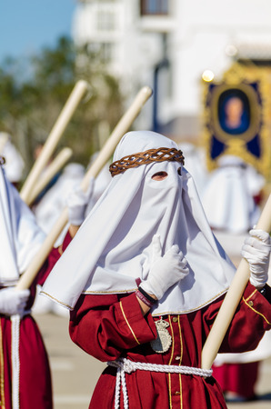 VELEZ-MALAGA, SPAIN - MARCH 27, 2018 People participating in the procession  in the Holy Week in a Spanish city, easterのeditorial素材