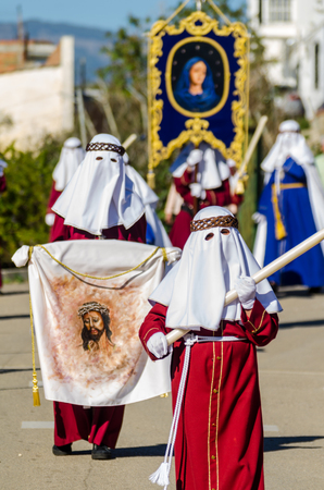 VELEZ-MALAGA, SPAIN - MARCH 27, 2018 People participating in the procession  in the Holy Week in a Spanish city, easterのeditorial素材