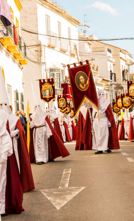 VELEZ-MALAGA, SPAIN - MARCH 25, 2018 People participating in the procession  in the Holy Week in a...