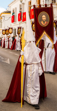 VELEZ-MALAGA, SPAIN - MARCH 25, 2018 People participating in the procession  in the Holy Week in a...