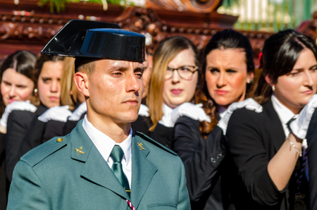 VELEZ-MALAGA, SPAIN - MARCH 27, 2018 People participating in the procession  in the Holy Week in a Spanish city, easterのeditorial素材