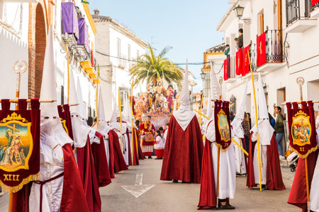 VELEZ-MALAGA, SPAIN - MARCH 25, 2018 People participating in the procession  in the Holy Week in a...