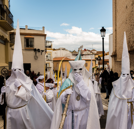 VELEZ-MALAGA, SPAIN - MARCH 25, 2018 People participating in the procession  in the Holy Week in a Spanish city, easterのeditorial素材