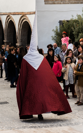 VELEZ-MALAGA, SPAIN - MARCH 25, 2018 People participating in the procession  in the Holy Week in a Spanish city, easterのeditorial素材