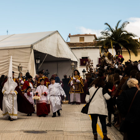 VELEZ-MALAGA, SPAIN - MARCH 25, 2018 People participating in the procession  in the Holy Week in a...