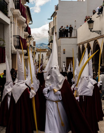 VELEZ-MALAGA, SPAIN - MARCH 25, 2018 People participating in the procession  in the Holy Week in a...