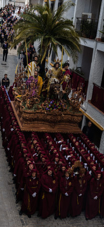 VELEZ-MALAGA, SPAIN - MARCH 25, 2018 People participating in the procession  in the Holy Week in a...