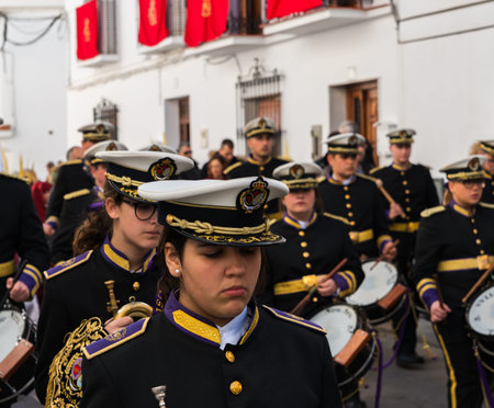 VELEZ-MALAGA, SPAIN - MARCH 25, 2018 People participating in the procession  in the Holy Week in a...