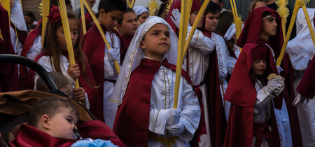 VELEZ-MALAGA, SPAIN - MARCH 25, 2018 People participating in the procession  in the Holy Week in a...