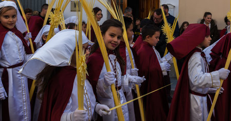 VELEZ-MALAGA, SPAIN - MARCH 25, 2018 People participating in the procession  in the Holy Week in a...