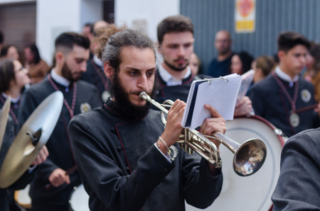 VELEZ-MALAGA, SPAIN - MARCH 25, 2018 People participating in the procession  in the Holy Week in a Spanish city, easterのeditorial素材