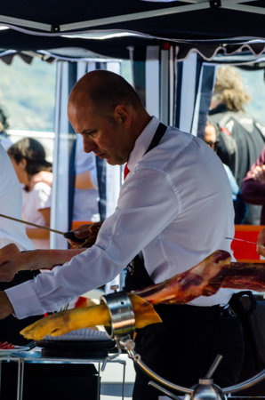 NERJA, SPAIN - APRIL 15, 2018 Traditional competition of professionals in the Jamon Serrano cutting event taking place in Nerja, Andalusia, a great demonstration of skillsのeditorial素材