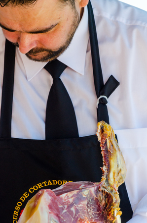 NERJA, SPAIN - APRIL 15, 2018 Traditional competition of professionals in the Jamon Serrano cutting event taking place in Nerja, Andalusia, a great demonstration of skillsのeditorial素材