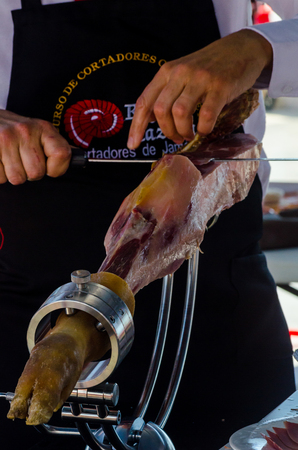 NERJA, SPAIN - APRIL 15, 2018 Traditional competition of professionals in the Jamon Serrano cutting event taking place in Nerja, Andalusia, a great demonstration of skillsのeditorial素材