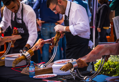 NERJA, SPAIN - APRIL 15, 2018 Traditional competition of professionals in the Jamon Serrano cutting event taking place in Nerja, Andalusia, a great demonstration of skillsのeditorial素材